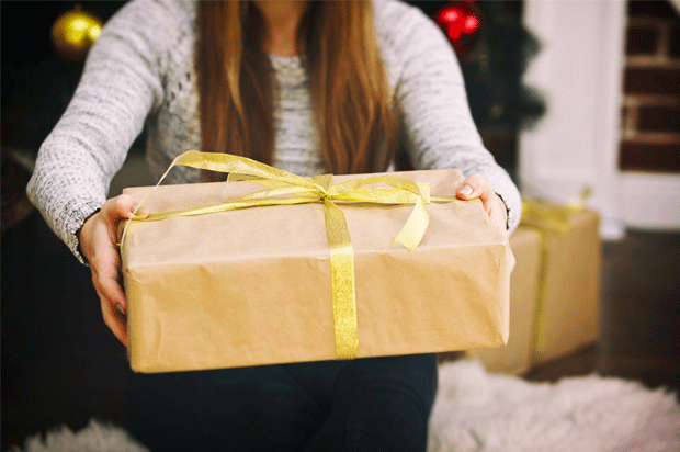girl holding out present